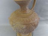 a vase that is sitting on a white surface