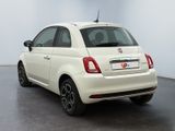the back of a white fiat car parked in a room