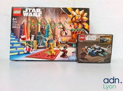 une boîte de Lego et un coffret Lego Star Wars posés sur une table