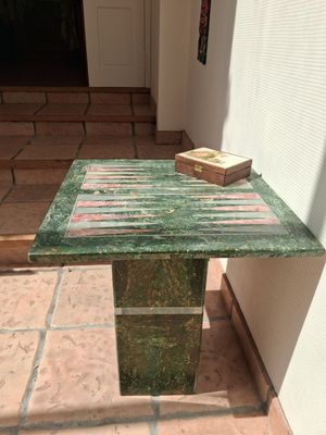 a green marble table with a book on top of it