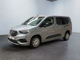 the silver van is parked inside of a white room