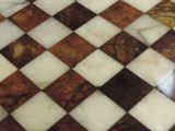 chess board with marble inlays on top of it on a table