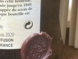 une étiquette sur une bouteille de vin posée sur une table