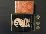 two cards and a coin on a black surface
