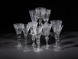 several empty wine glasses on a table with a black background