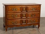 an antique chest of drawers with a marble top and brass handles