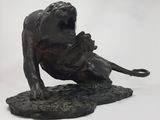 statue of a lion on a rock with its mouth open