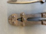 a knife and a pair of pliers on a table
