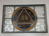a picture of a stained glass window with a clock on it