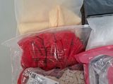many bags of clothes that are sitting on a table