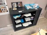 a desk with a computer and a bunch of papers on it