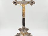 a silver and gold cross with a cross on top of it
