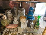 a glass display case with various glass items on it