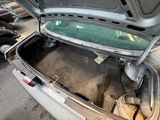 an open trunk of a car in a garage