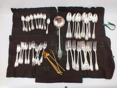a lot of spoons and forks laid out on the table