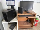 a desk with a computer and a monitor on it
