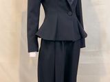 a mannequin wearing a suit and tie on a mannequin stand