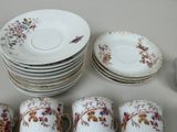 a lot of plates and cups sitting on a table