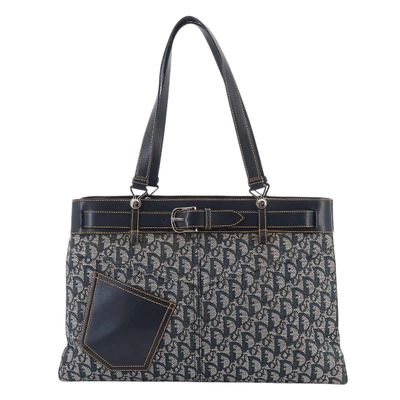 a black and white handbag with a pocket on the front