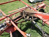 a tractor that is sitting on the grass in the field