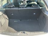 the back of a car with the trunk open and the seats folded down