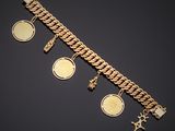 a close up of a gold bracelet with coins and charms