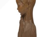 sculpture of a boy ' s head on a wooden base