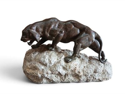 statue of a panther on a rock on a white background