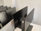 three televisions that are sitting on a desk