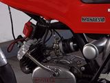 a red motorcycle that is parked in a garage