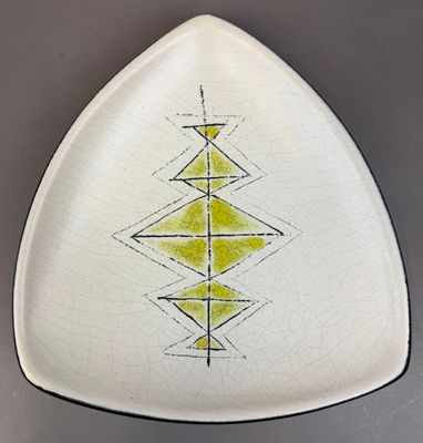 a white plate with yellow and black designs on it