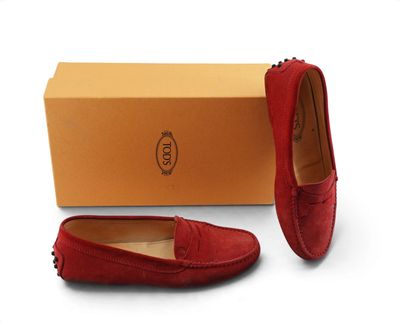 a pair of red sued shoes with a box on the side