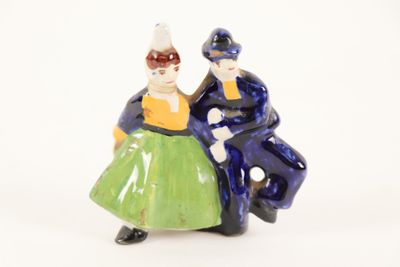two figurines of a man and a woman standing next to each other