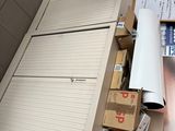 a refrigerator sitting on top of a counter in a kitchen