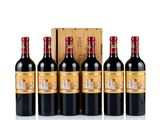 four bottles of red wine in front of a wooden box