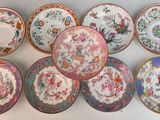 six plates with floral designs are arranged on a white surface
