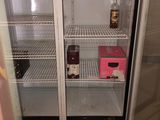 a refrigerator that has two bottles of wine in it