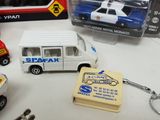 many different toy cars and key chains on a table