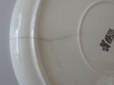 a white plate with a black and blue design on it