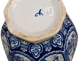 a blue and white vase with a bird on it