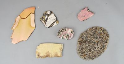 cinq types de roches différents sur une surface grise