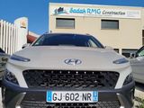 the front of a silver car parked in front of a building