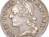 gros plan d'une pièce de monnaie sur laquelle figure une tête de femme