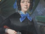 portrait of a woman in a black dress with a blue bow