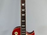 an electric guitar sitting on top of a white surface