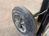 a close up of a black wheel on a metal pole