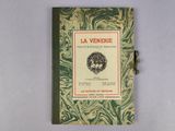 an old book with a green and white cover on a white surface
