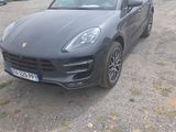 a black porsche cayen parked in a parking lot