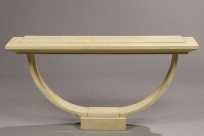 an image of a wooden table with a curved base on a grey background
