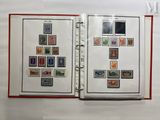 an open book with stamps on it sitting on a table